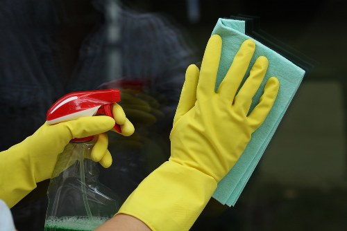 Cleaning staff following safe working practices during a professional cleaning task